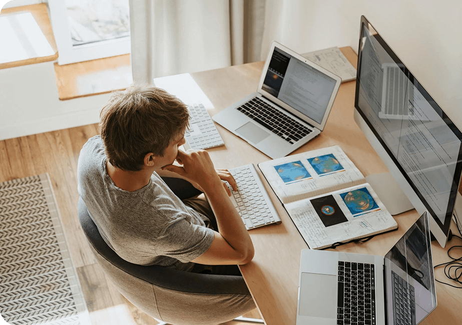 A person infront of his computer doing research